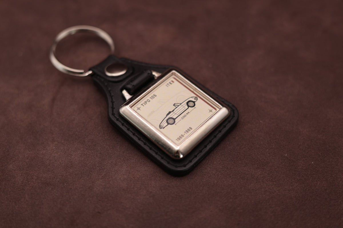Alfa Romeo Spider 105 Register Series keyring angled with the split ring at upper left, showing the square chromed frame