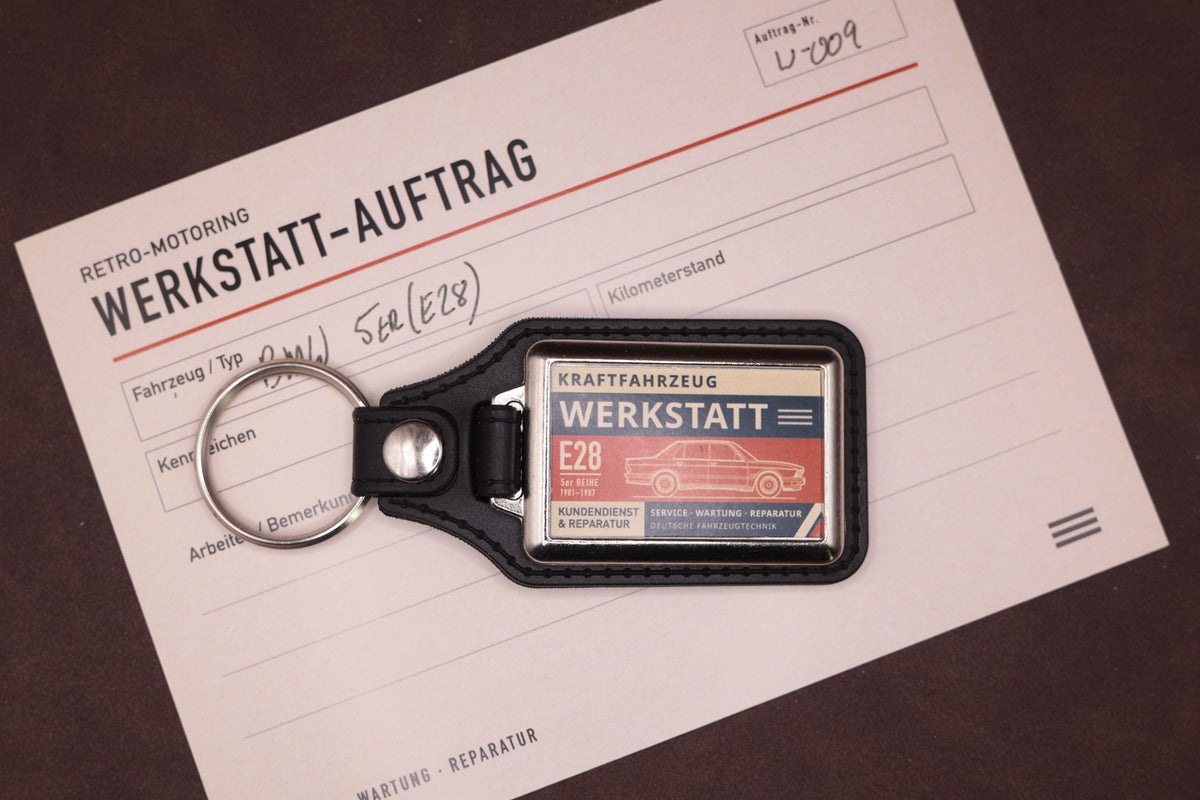 BMW E28 Werkstatt keyring photographed with a Werkstatt reference card