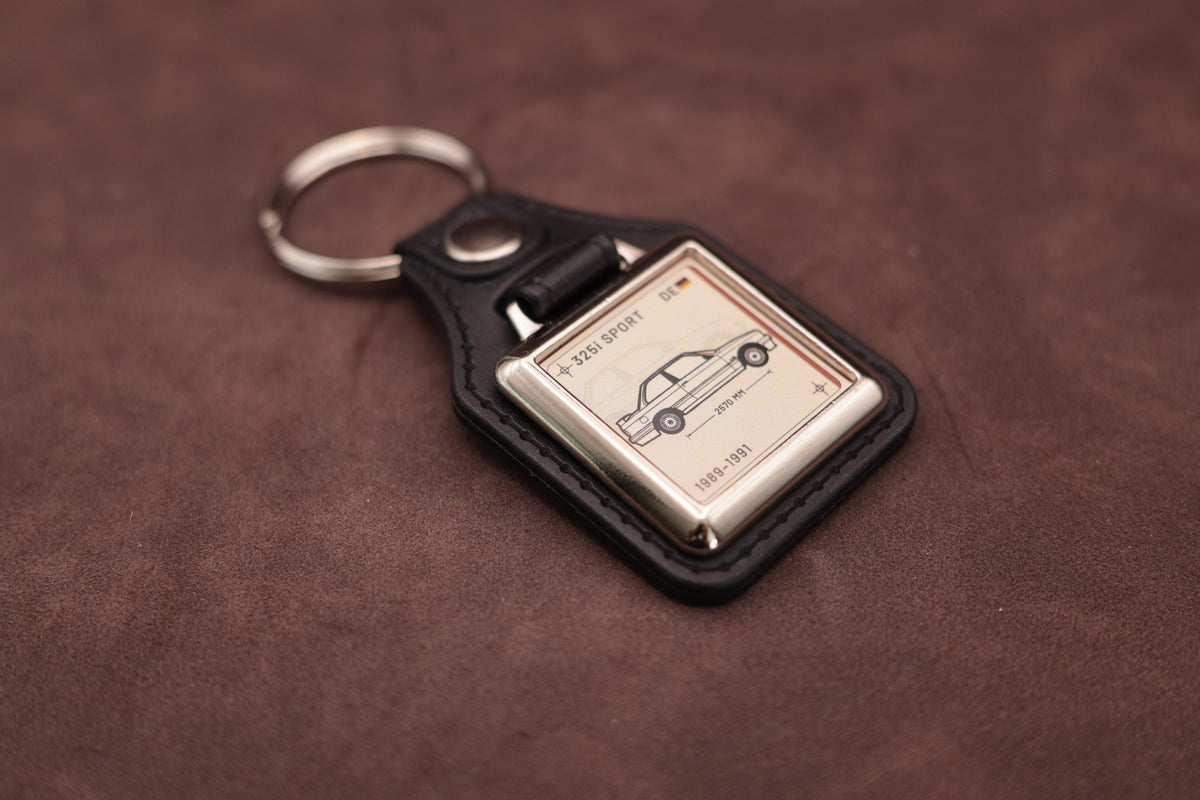 BMW E30 325i Register Series keyring angled with the split ring at upper left, showing the square chromed frame