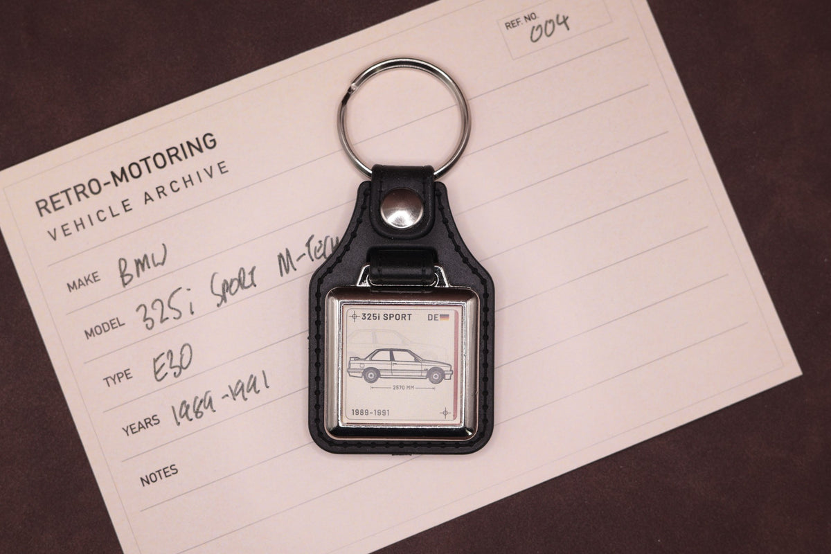 BMW E30 325i Register Series keyring photographed on a Retro-Motoring vehicle archive card
