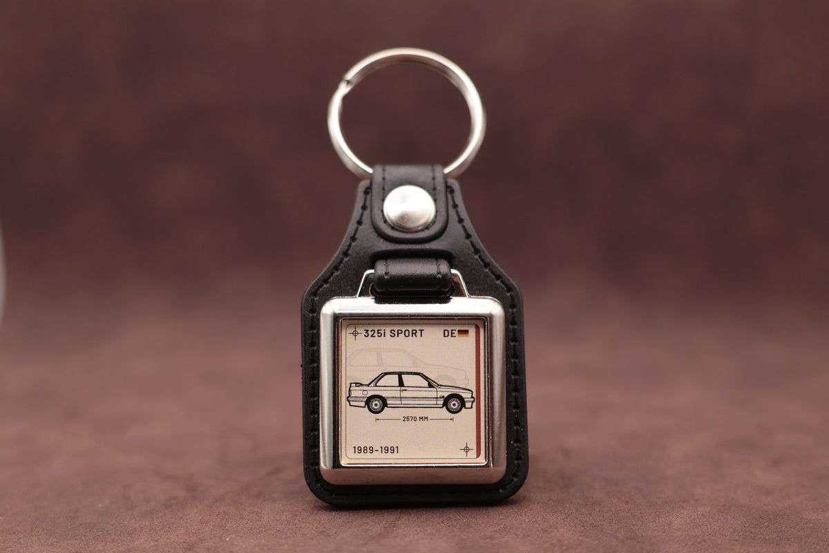 BMW E30 325i Register Series keyring with ivory insert and side-profile vehicle illustration