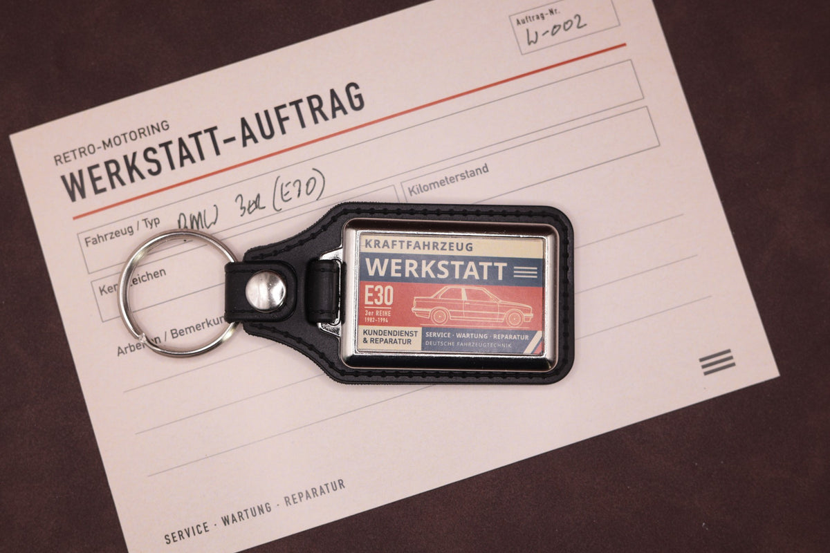 BMW E30 Werkstatt keyring photographed with a Werkstatt reference card