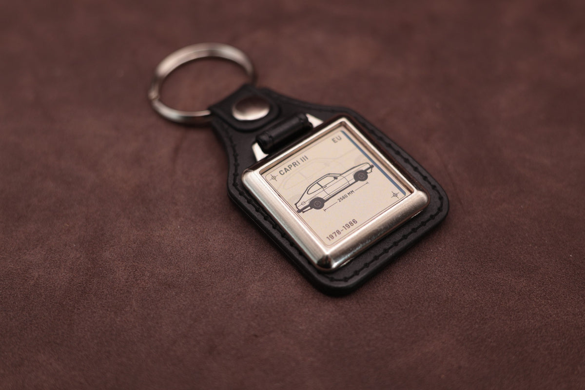 Ford Capri Mk3 Register Series keyring angled with the split ring at upper left, showing the square chromed frame