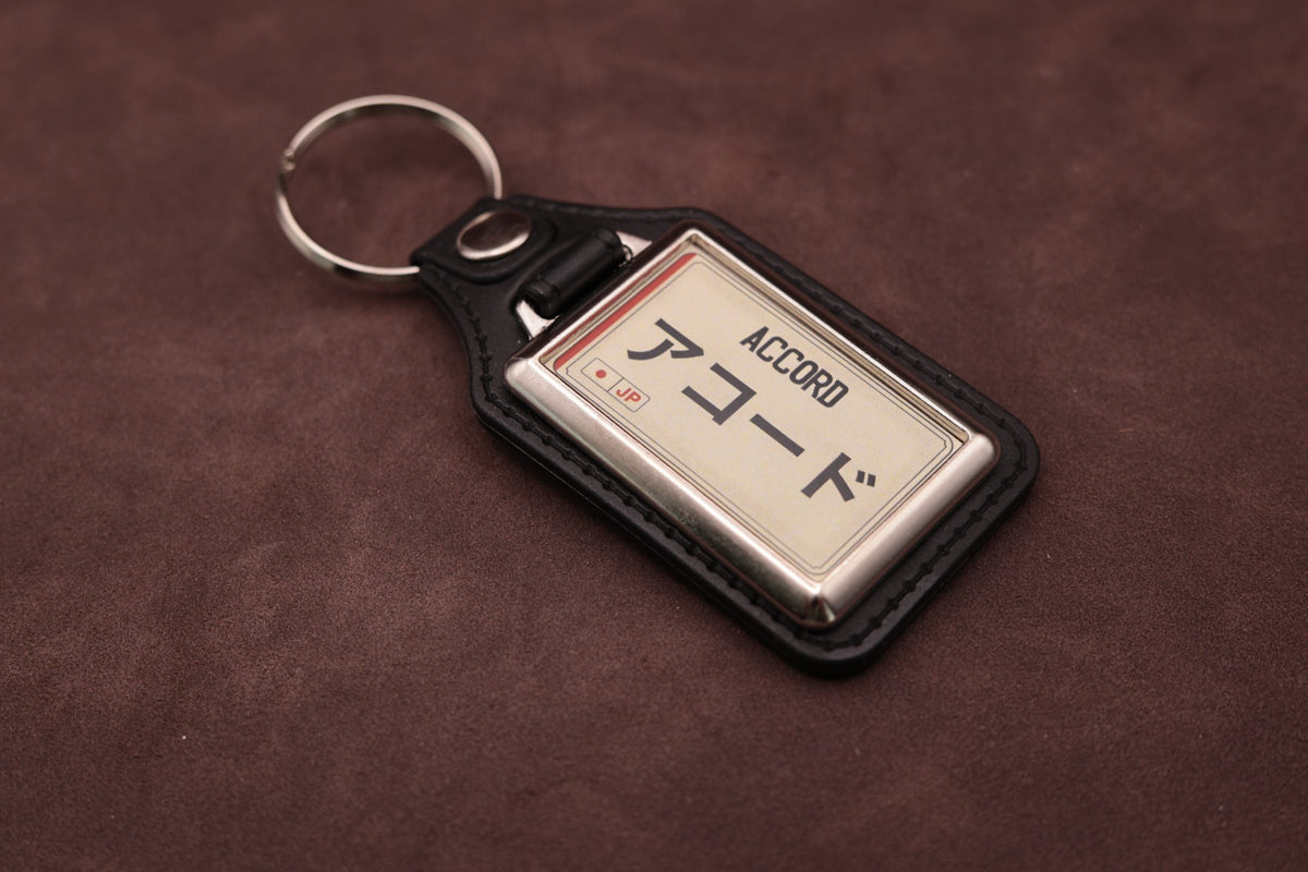 Honda Accord Katakana keyring angled with the split ring at upper left, showing the printed insert and chromed frame
