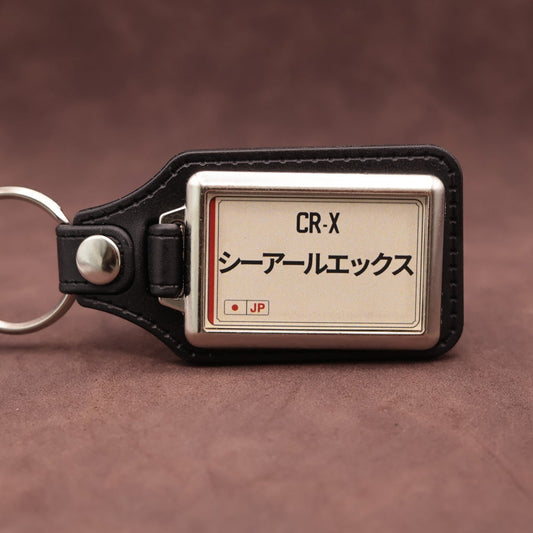 Honda CR-X keyring with Japanese katakana and model lettering on a cream plate-inspired insert