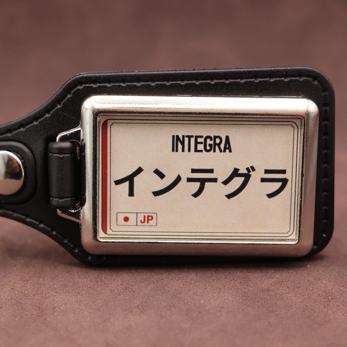 Honda Integra keyring with Japanese katakana and model lettering on a cream plate-inspired insert