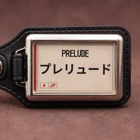 Honda Prelude keyring with Japanese katakana and model lettering on a cream plate-inspired insert