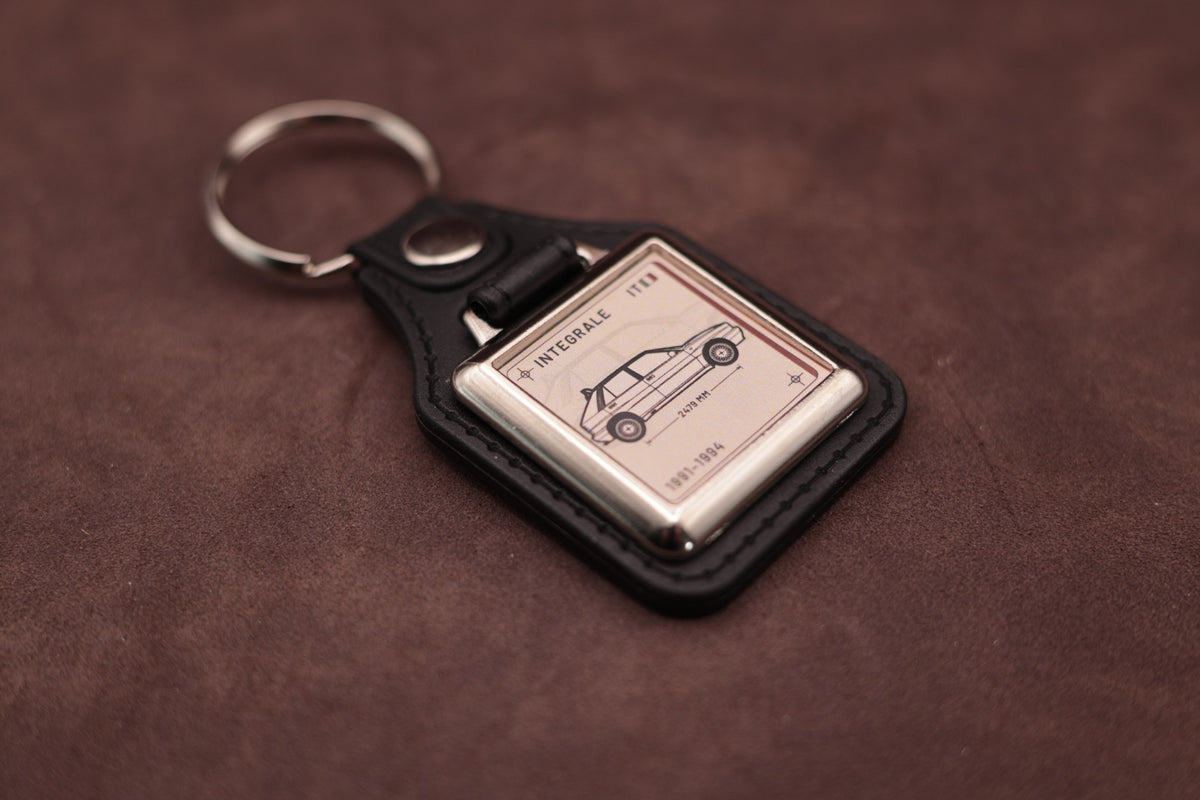 Lancia Delta Integrale Register Series keyring angled with the split ring at upper left, showing the square chromed frame