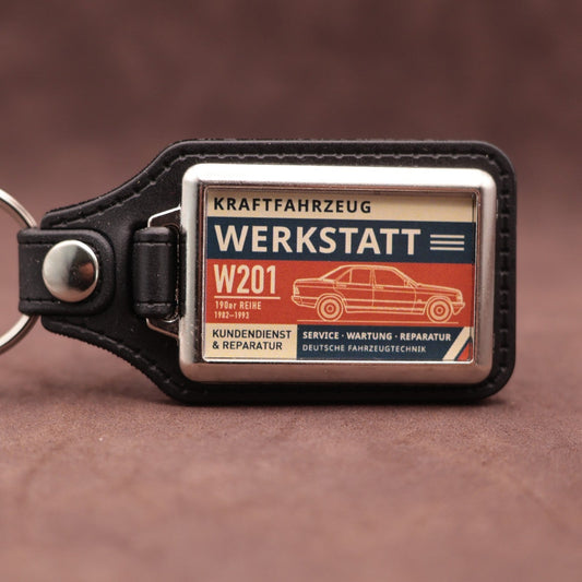 Mercedes-Benz W201 190 Werkstatt keyring with cream, dark blue and rust red workshop lettering and vehicle illustration