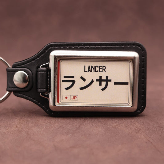 Mitsubishi Lancer keyring with Japanese katakana and model lettering on a cream plate-inspired insert