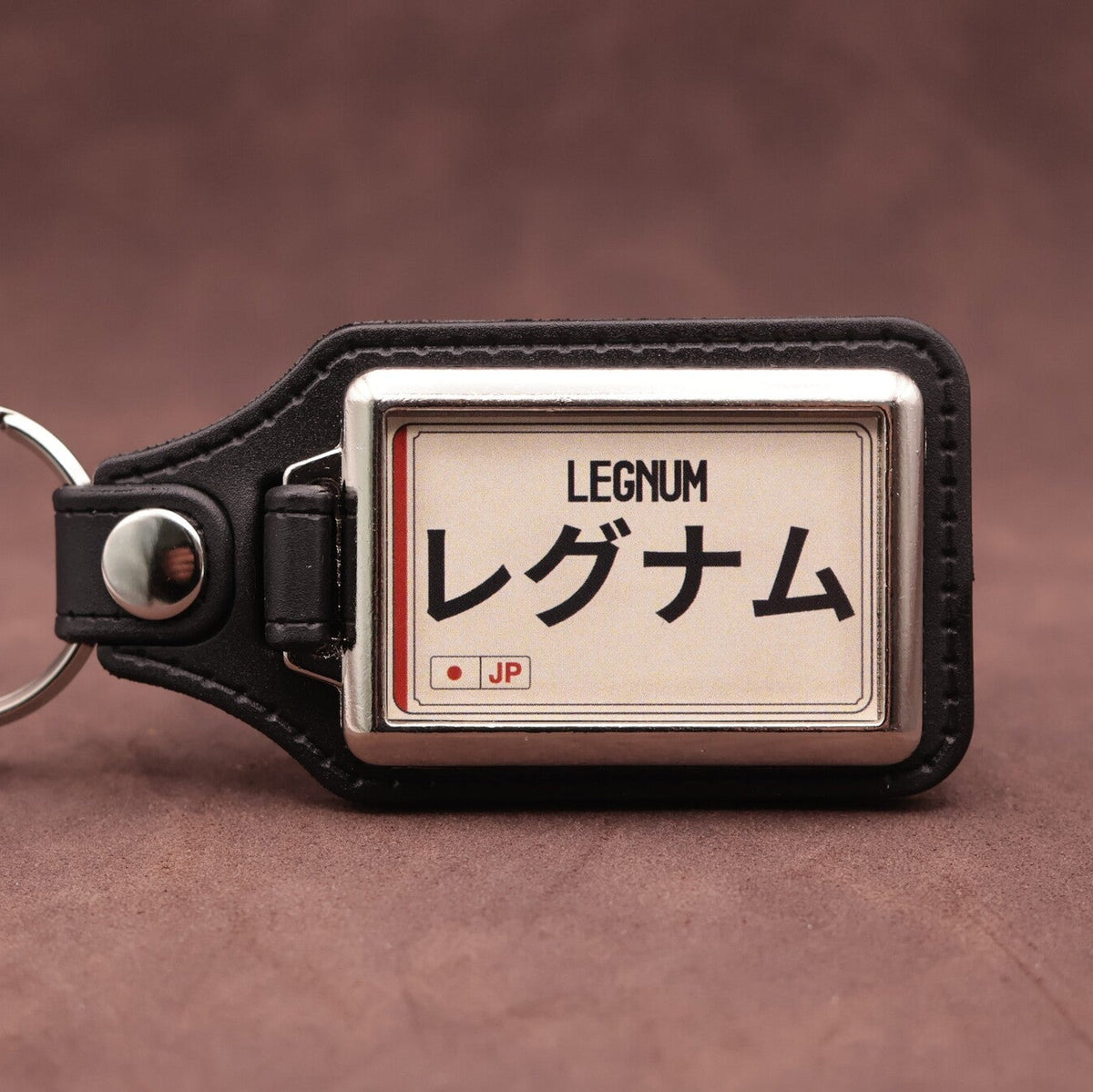 Mitsubishi Legnum keyring with Japanese katakana and model lettering on a cream plate-inspired insert