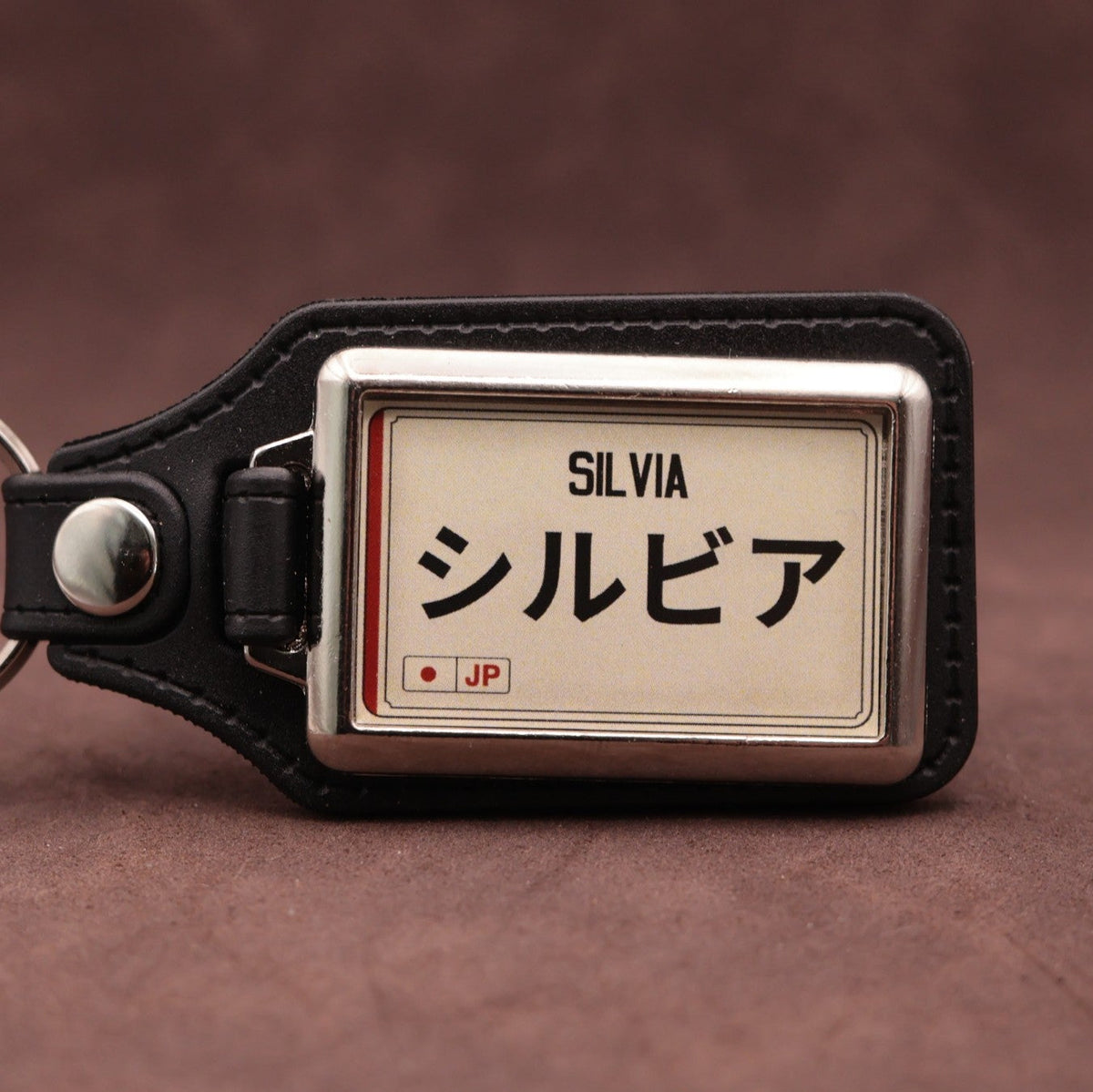 Nissan Silvia keyring with Japanese katakana and model lettering on a cream plate-inspired insert