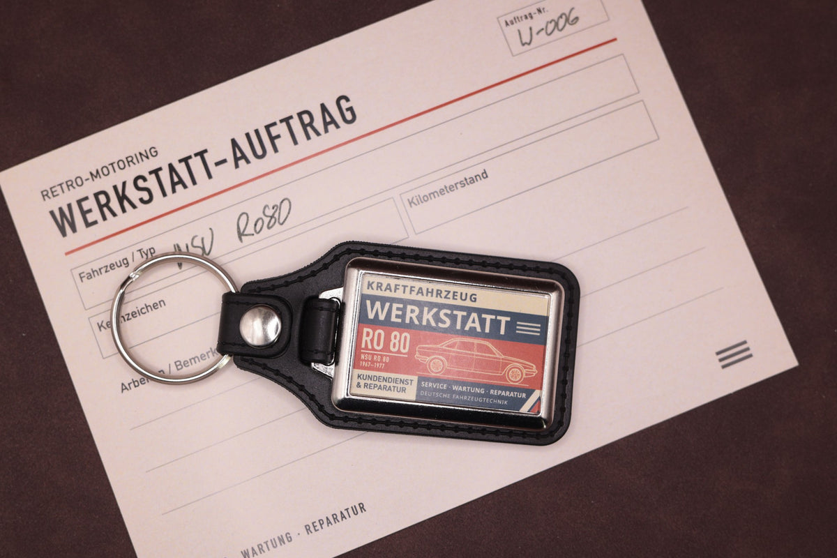 NSU Ro80 Werkstatt keyring photographed with a Werkstatt reference card