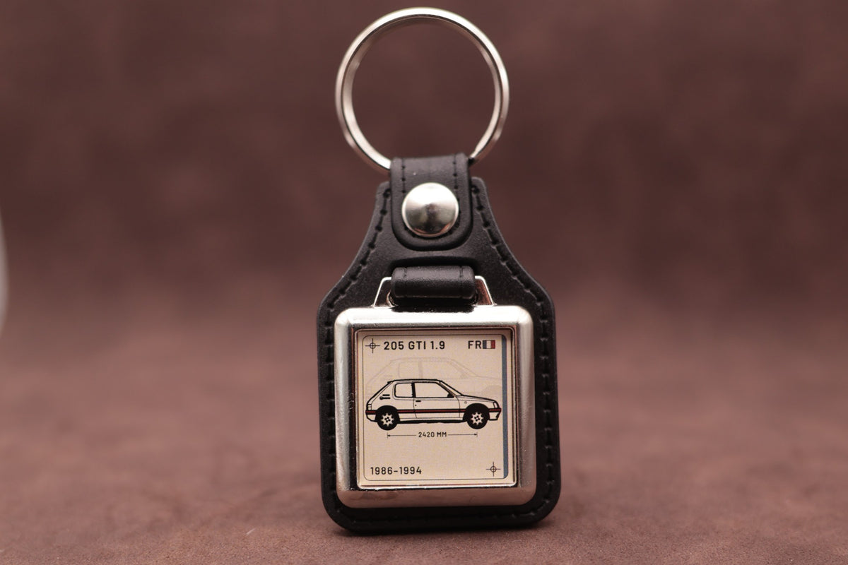 Peugeot 205 GTI 1.9 Register Series keyring with ivory insert and side-profile vehicle illustration