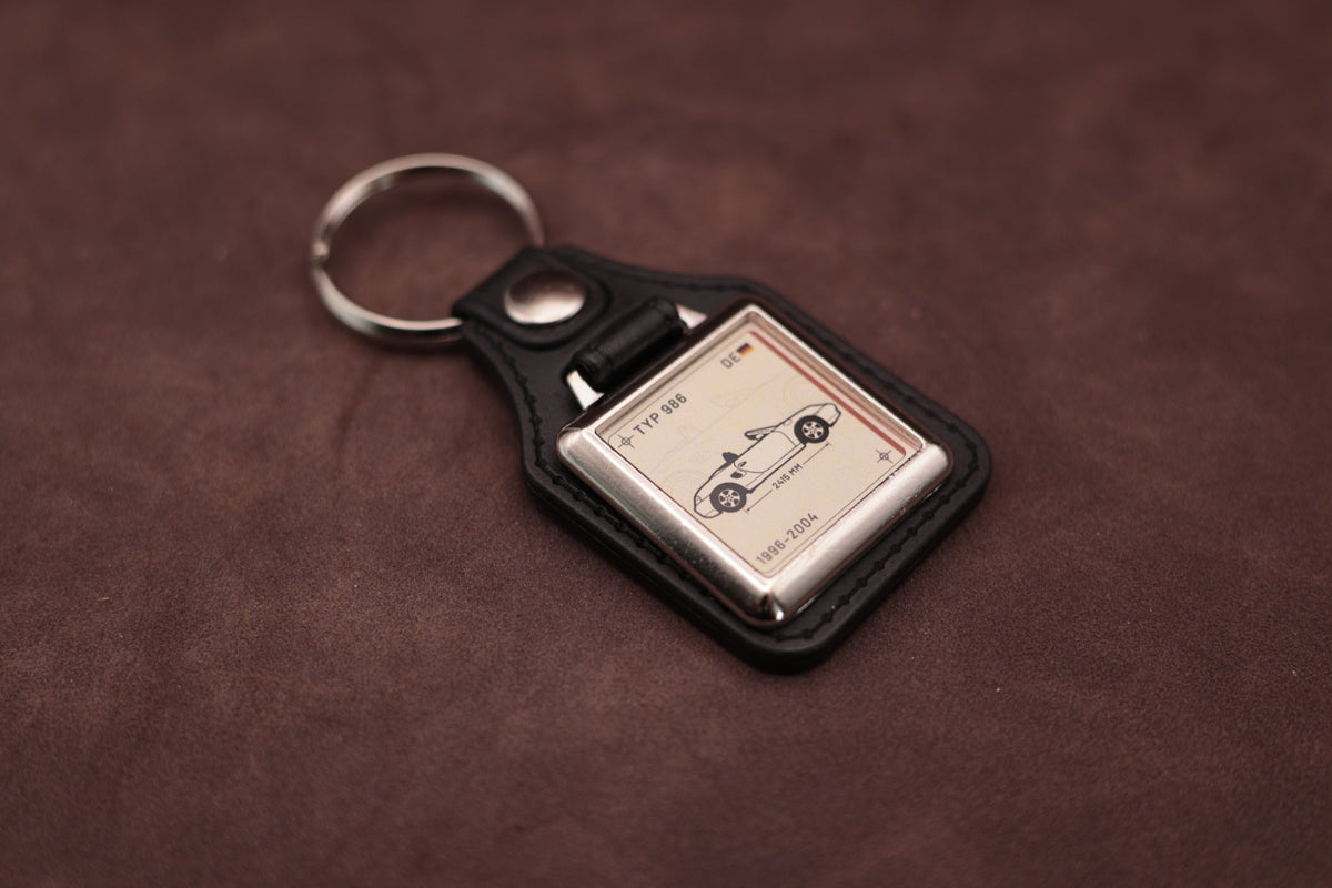 Porsche Boxster 986 Register Series keyring angled with the split ring at upper left, showing the square chromed frame