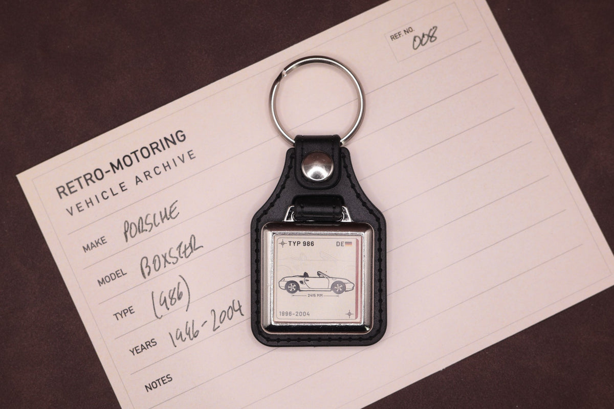 Porsche Boxster 986 Register Series keyring photographed on a Retro-Motoring vehicle archive card