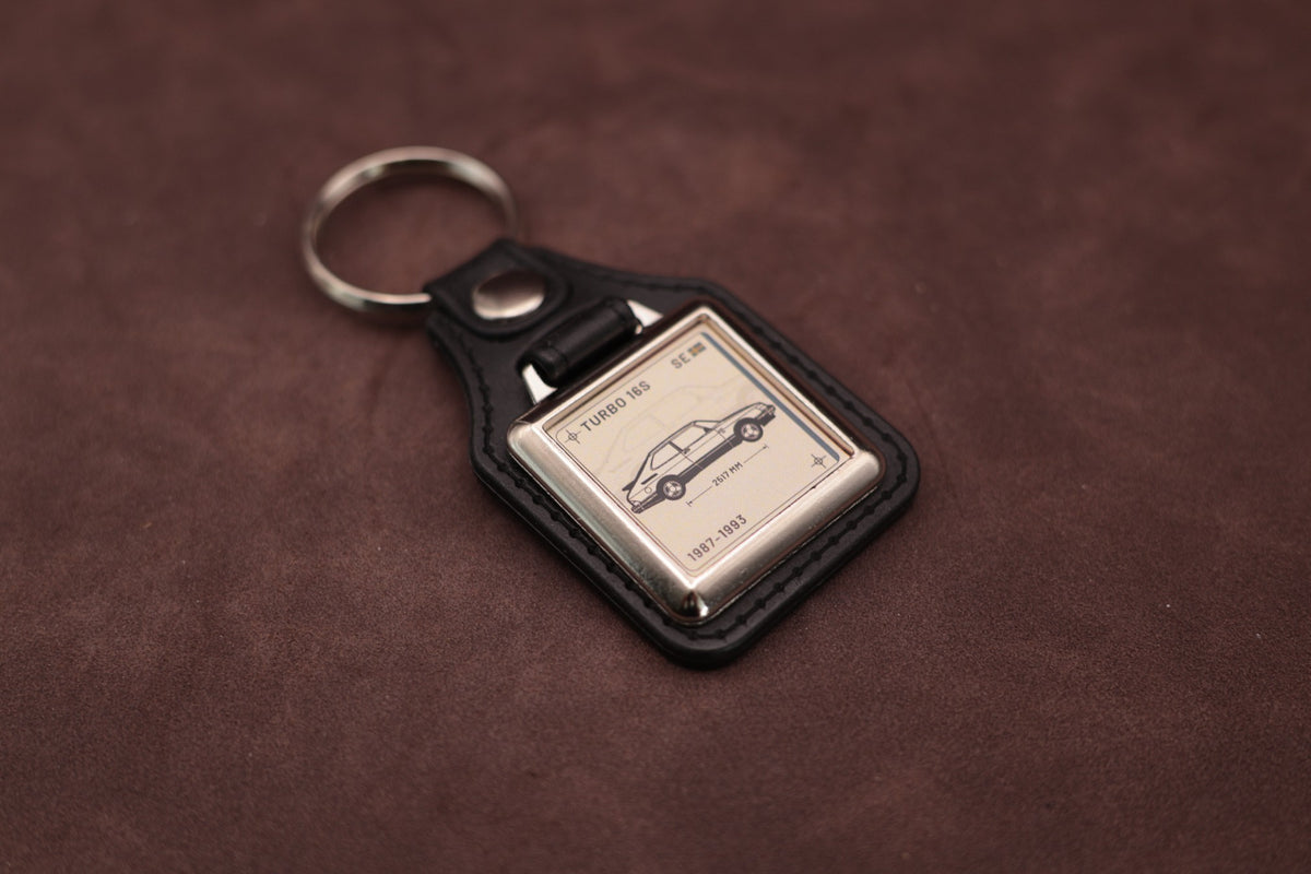 Saab 900 Turbo 16S Register Series keyring angled with the split ring at upper left, showing the square chromed frame
