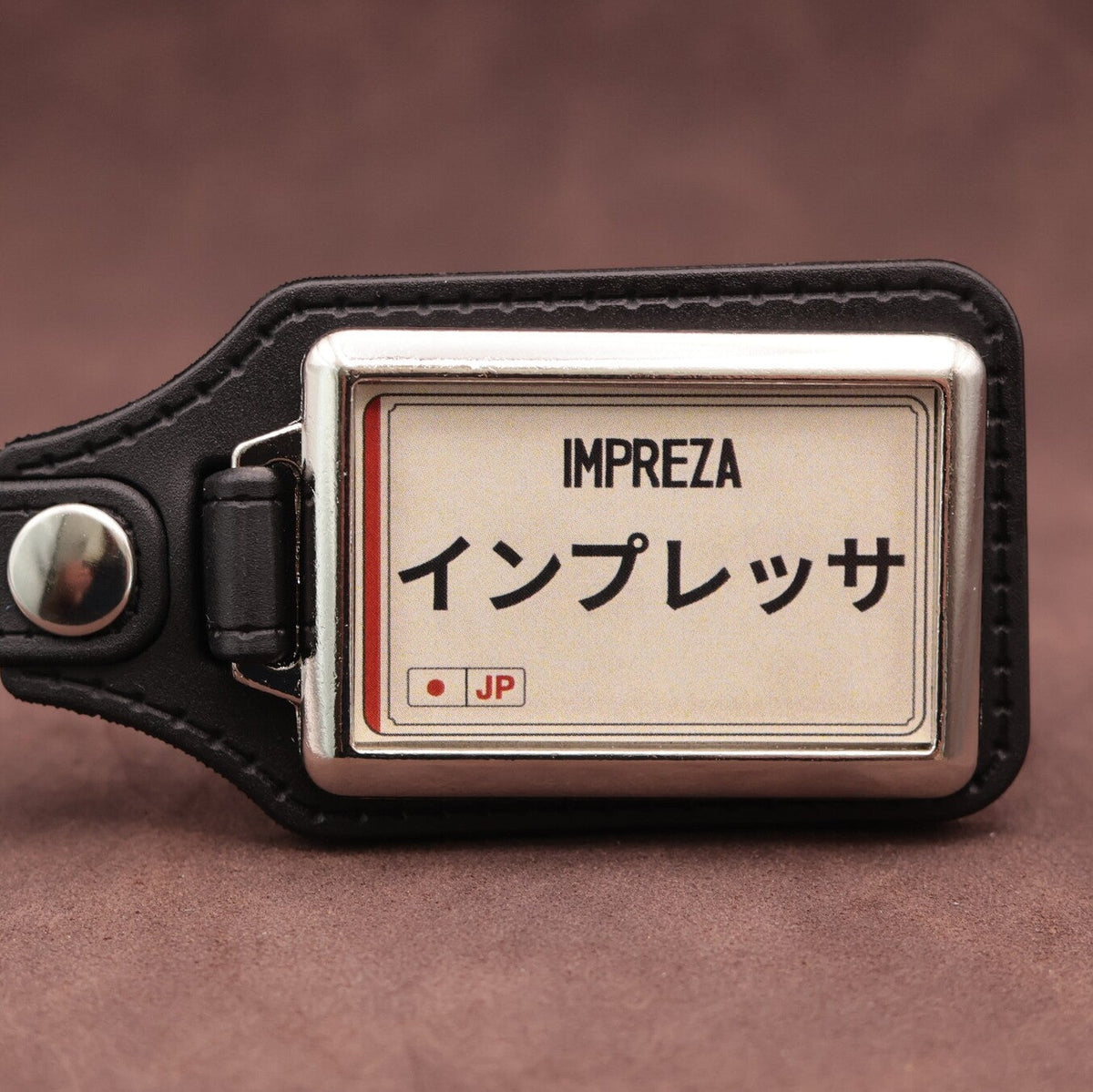 Subaru Impreza keyring with Japanese katakana and model lettering on a cream plate-inspired insert