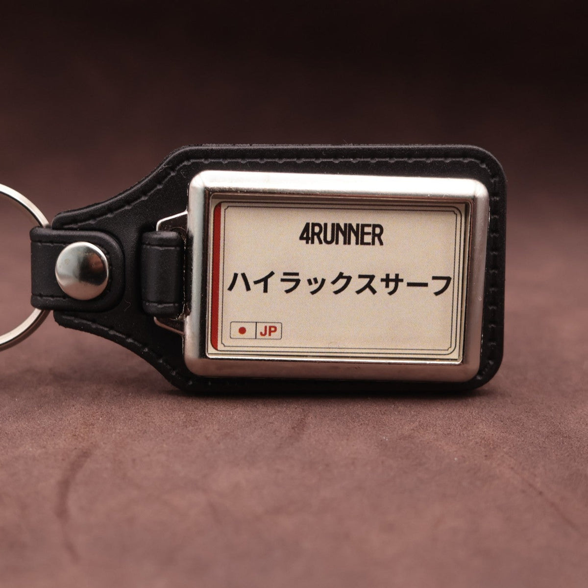 Toyota 4Runner keyring with Japanese katakana and model lettering on a cream plate-inspired insert