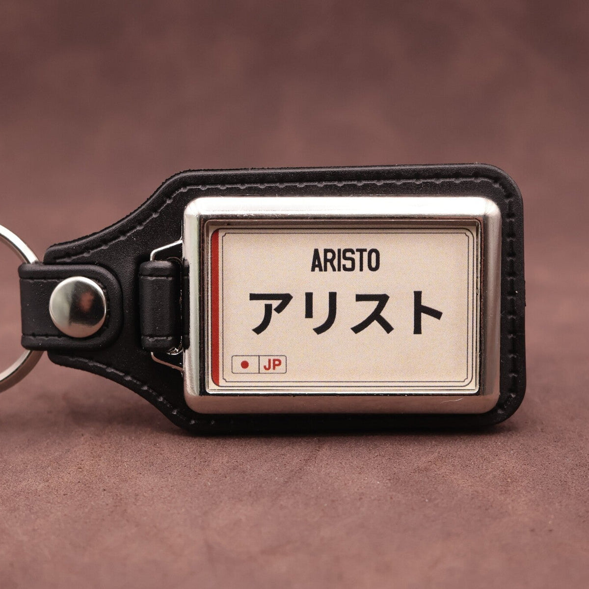 Toyota Aristo keyring with Japanese katakana and model lettering on a cream plate-inspired insert