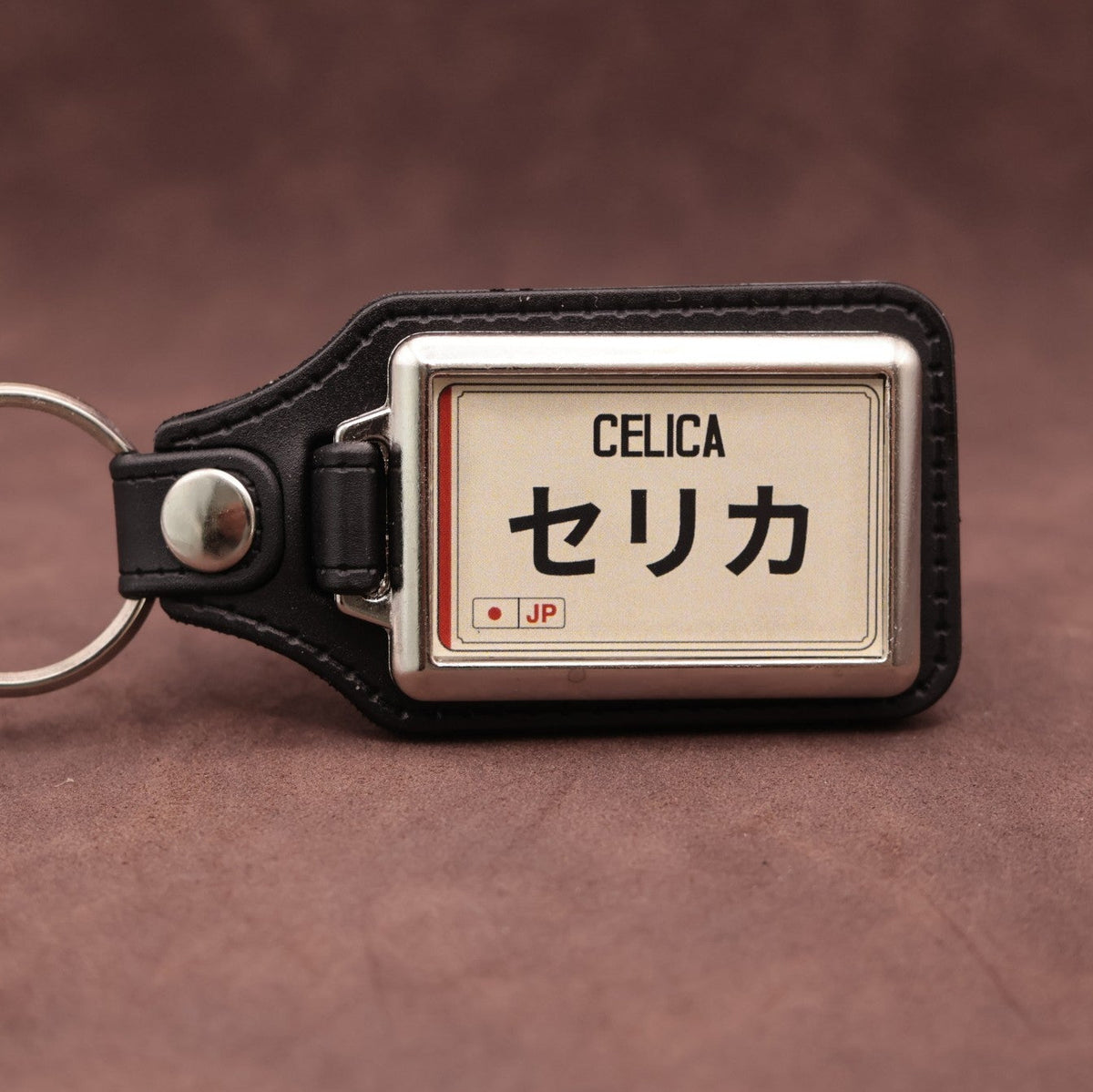 Toyota Celica keyring with Japanese katakana and model lettering on a cream plate-inspired insert