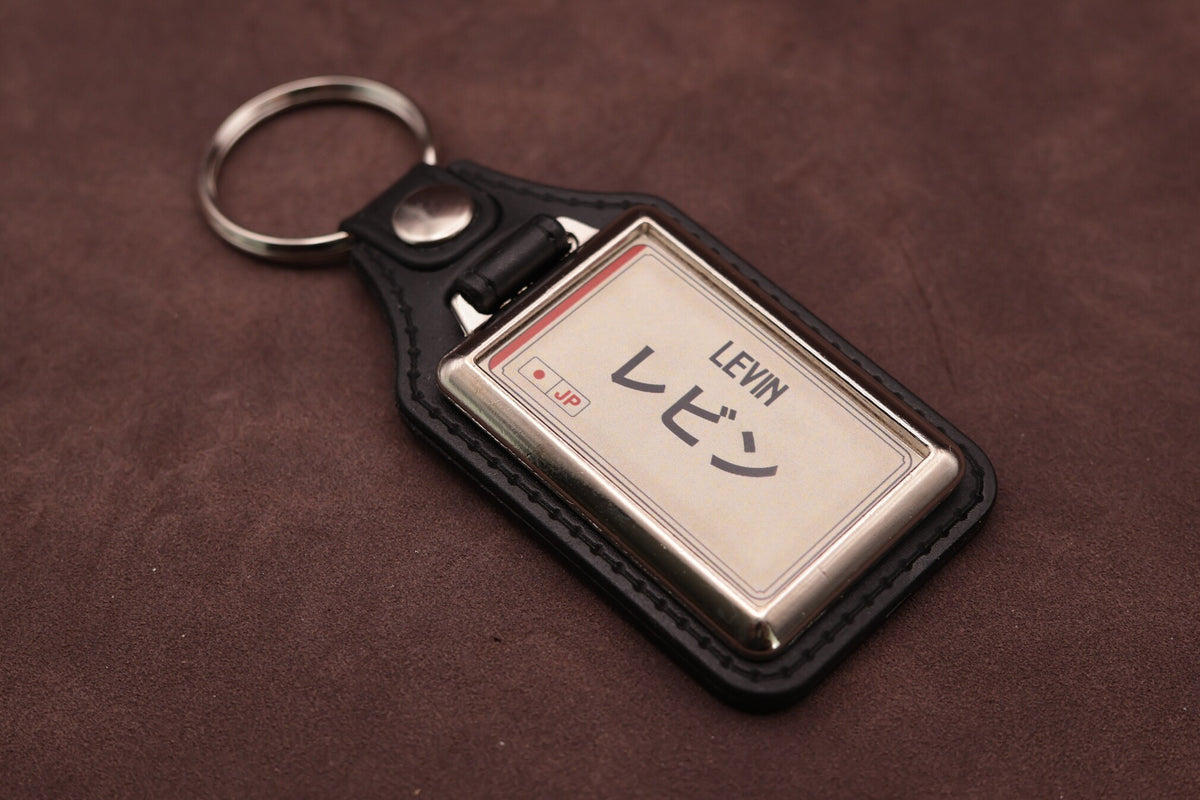 Toyota Levin Katakana keyring angled with the split ring at upper left, showing the printed insert and chromed frame