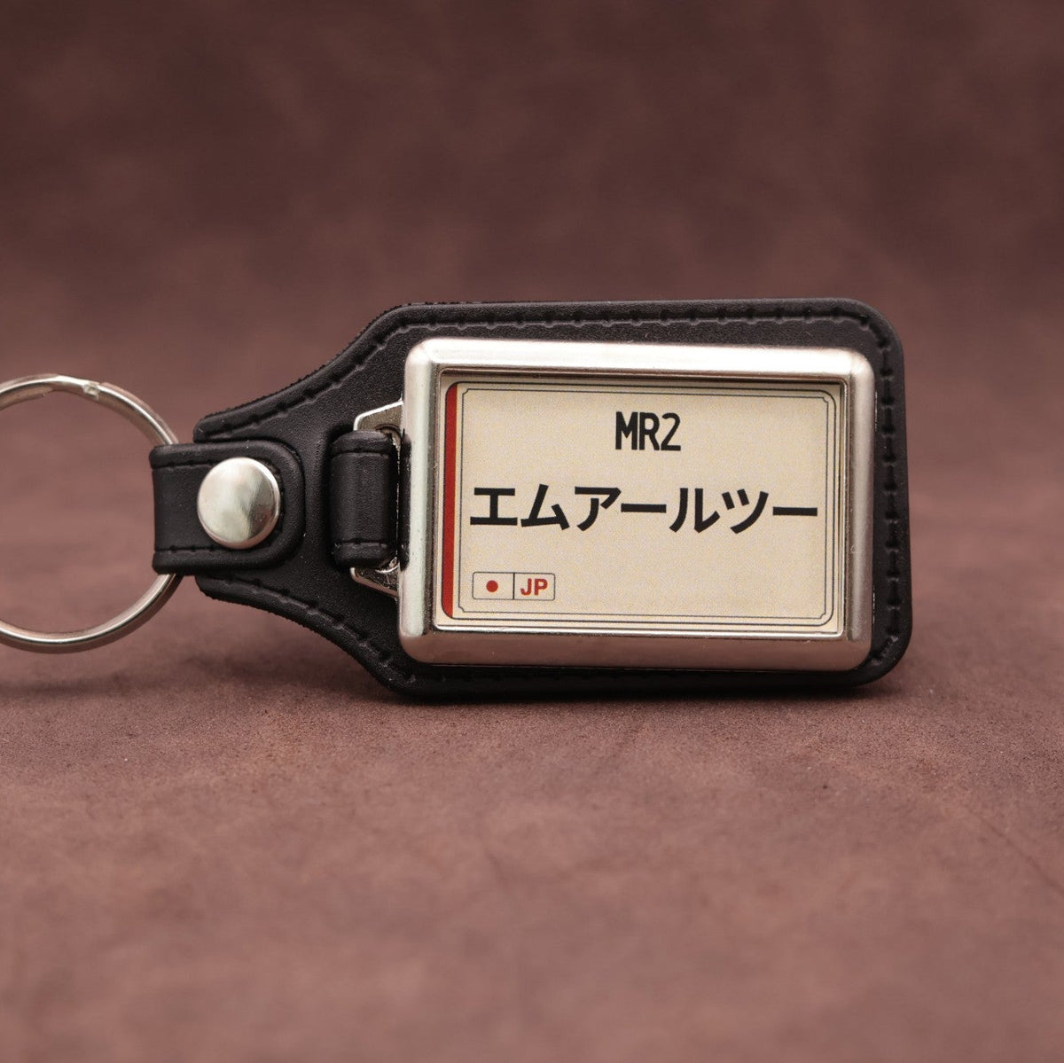 Toyota MR2 keyring with Japanese katakana and model lettering on a cream plate-inspired insert