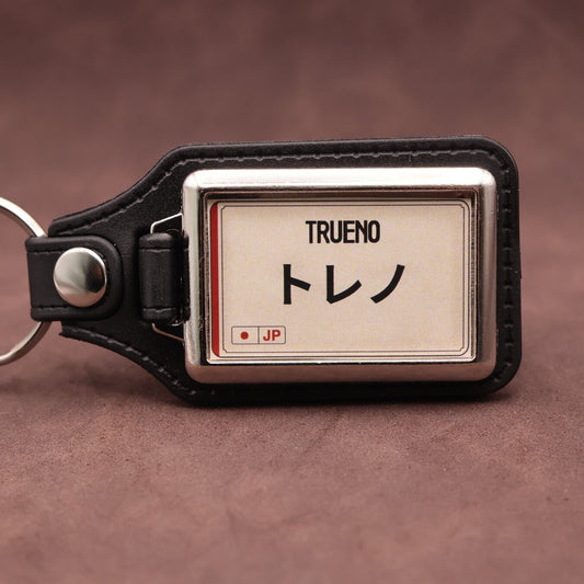 Toyota Trueno keyring with Japanese katakana and model lettering on a cream plate-inspired insert
