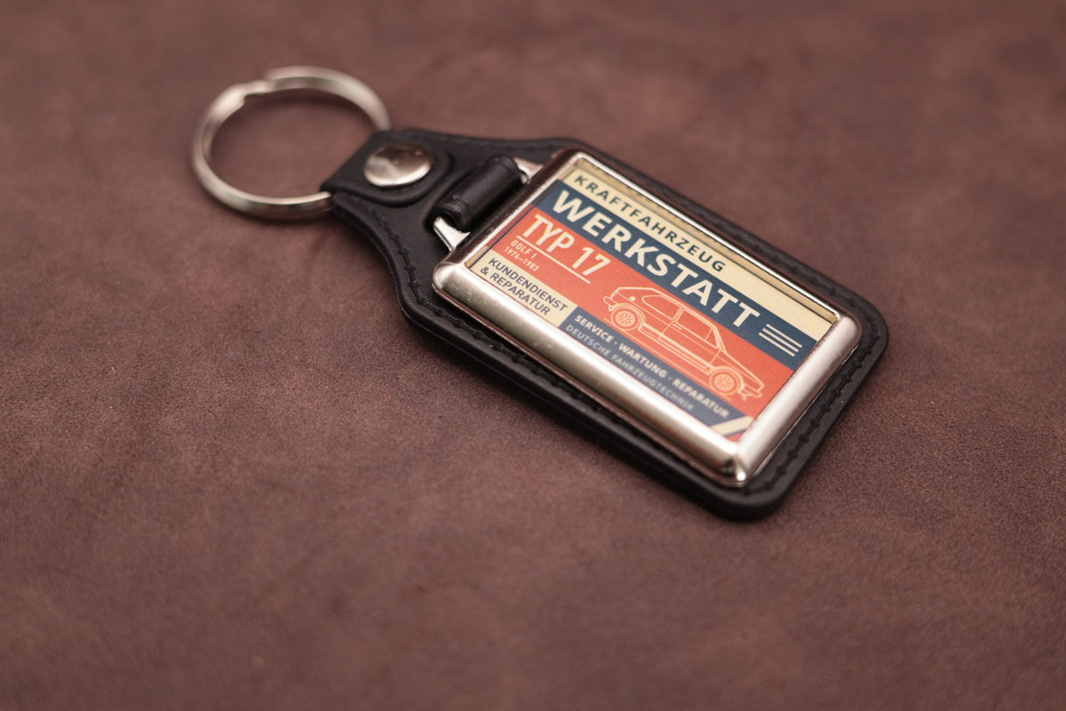 Volkswagen Golf Mk1 Werkstatt keyring angled with the split ring at lower left, showing the printed label and black leatherette fob