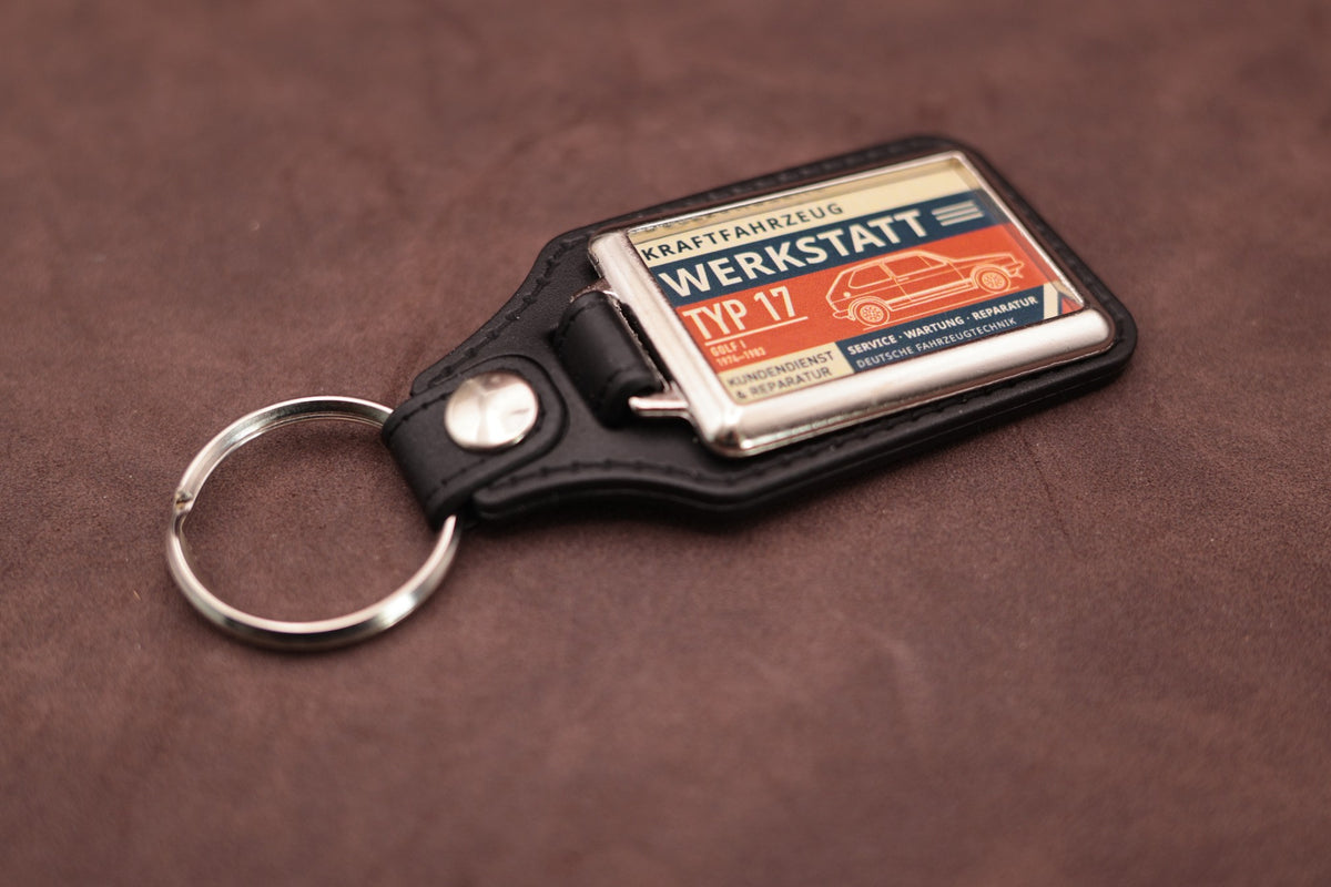 Volkswagen Golf Mk1 Werkstatt keyring angled with the split ring at upper left, showing the printed label and chromed frame
