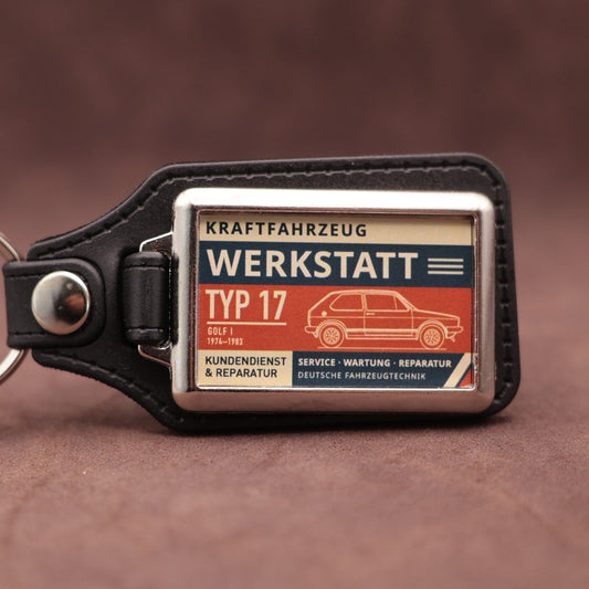 Volkswagen Golf Mk1 Werkstatt keyring with cream, dark blue and rust red workshop lettering and vehicle illustration