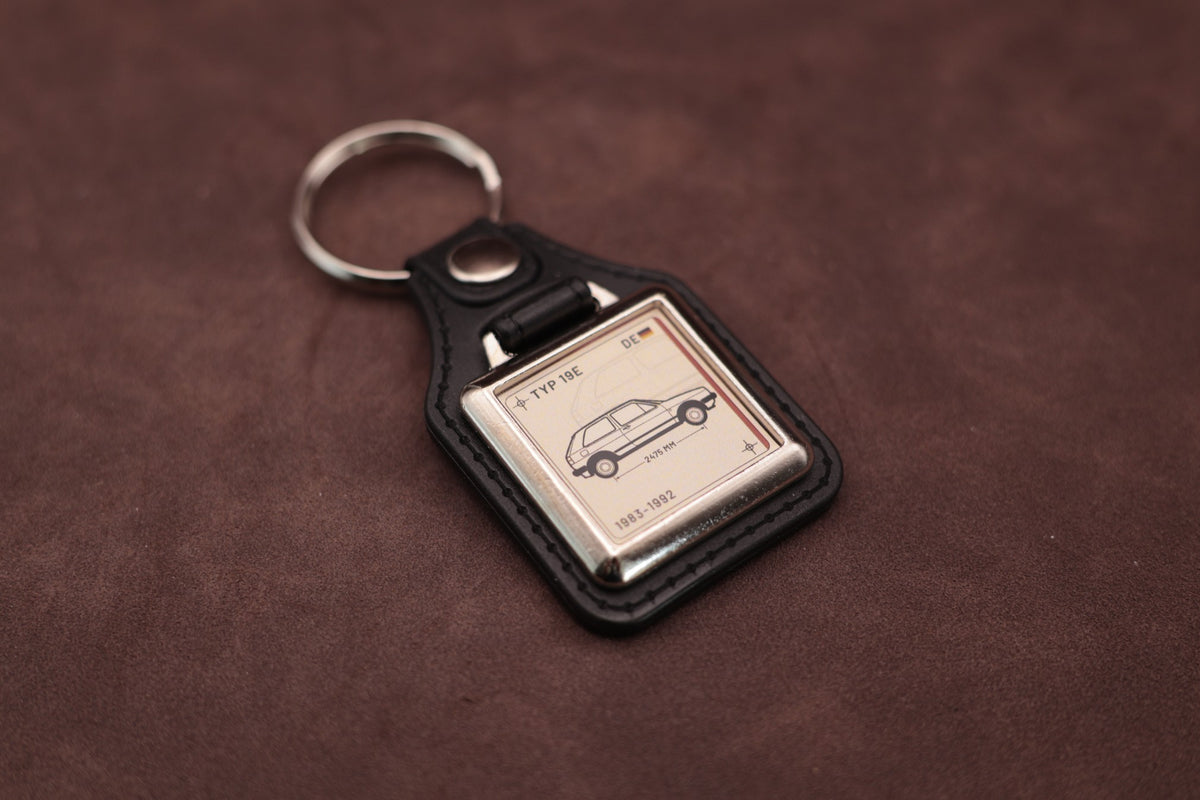 Volkswagen Golf Mk2 Register Series keyring angled with the split ring at upper left, showing the square chromed frame