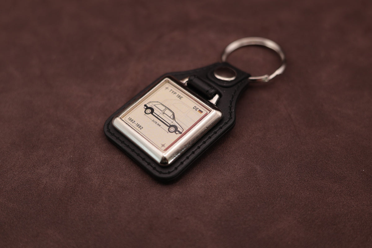 Volkswagen Golf Mk2 Register Series keyring angled with the split ring at upper right and ivory vehicle artwork visible