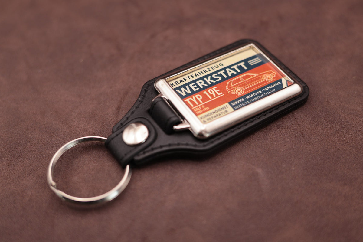 Volkswagen Golf Mk2 Werkstatt keyring angled with the split ring at lower left, showing the printed label and black leatherette fob