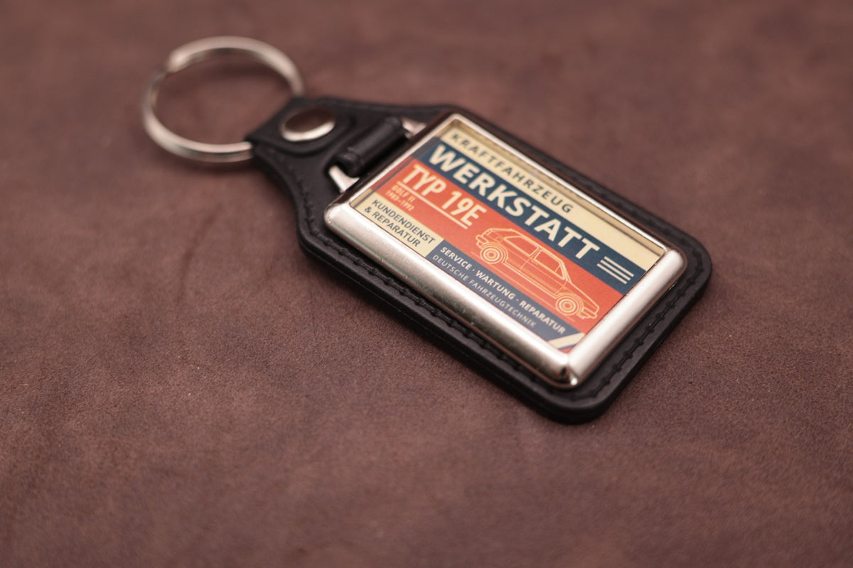 Volkswagen Golf Mk2 Werkstatt keyring angled with the split ring at upper left, showing the printed label and chromed frame