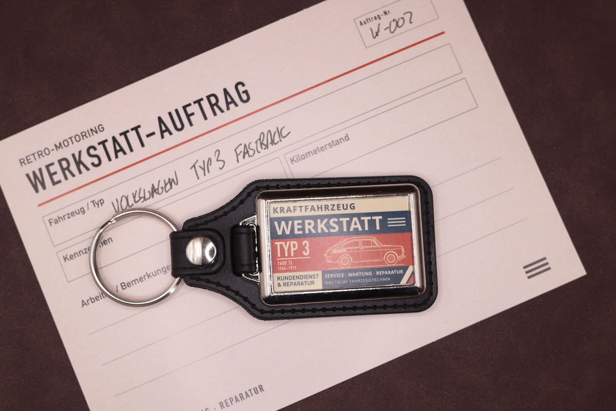 Volkswagen Type 3 Fastback Werkstatt keyring photographed with a Werkstatt reference card